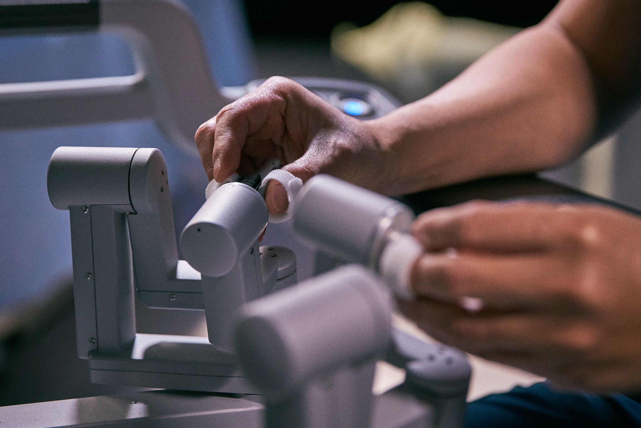 Surgeon's hands navigating the system controls