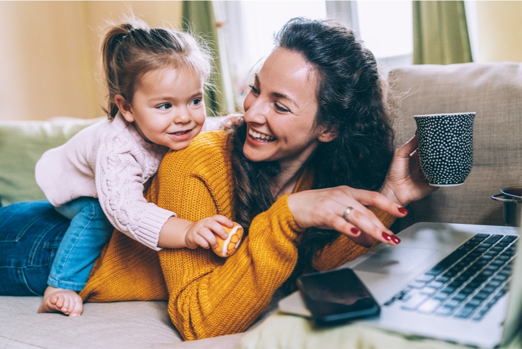 Woman laptop baby on back
