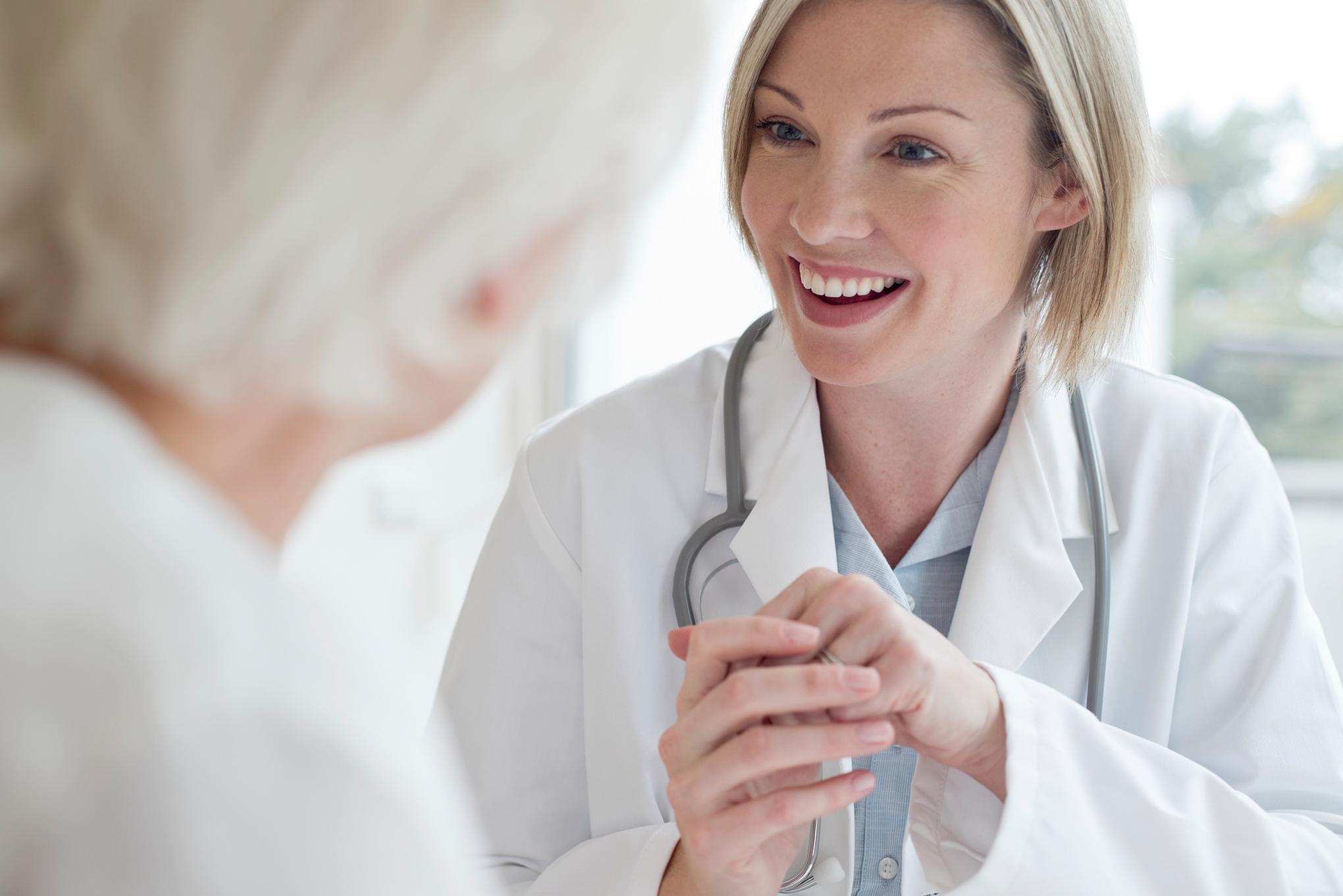 Woman physician talking senior patient
