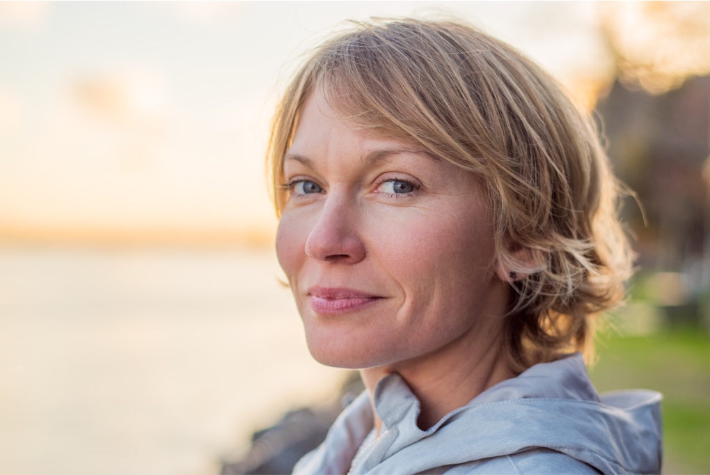 Woman smiling by lake