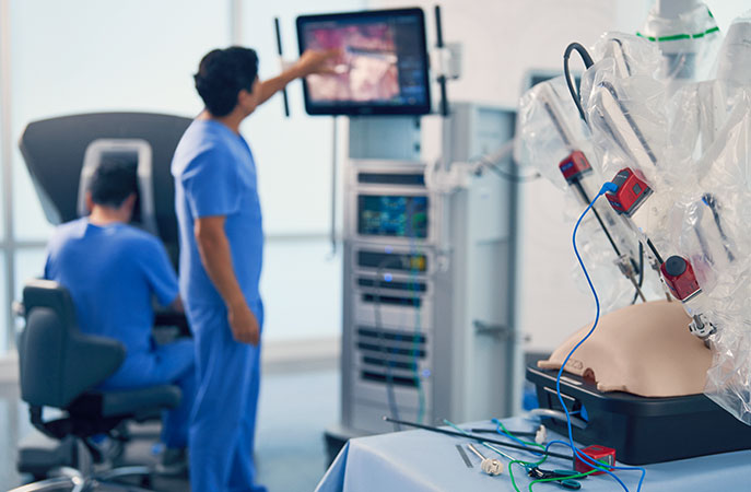 Training resident surgeon inspects screen on vision cart